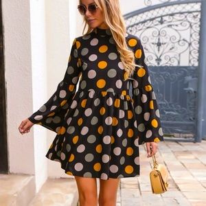 Polka Dot Mock neck a-line dress. Tie accent in the back and trumpet sleeves.NEW